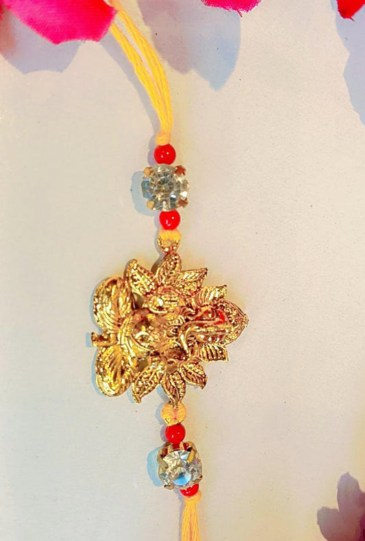 Handmade Ganesha Rakhi – Golden Finish with Red Beads & Crystal Stones (Single Piece)