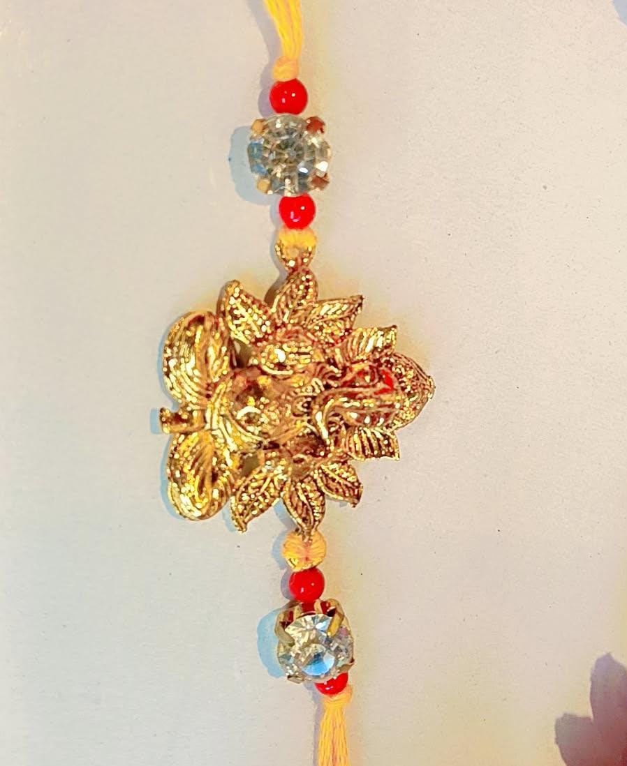 Handmade Ganesha Rakhi – Golden Finish with Red Beads & Crystal Stones (Single Piece)