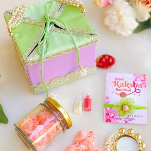 Handmade Bhaiya Bhabhi Rakhi Gift Box – With Jar Flowers, Pearl Candle & Greeting Card (35g)