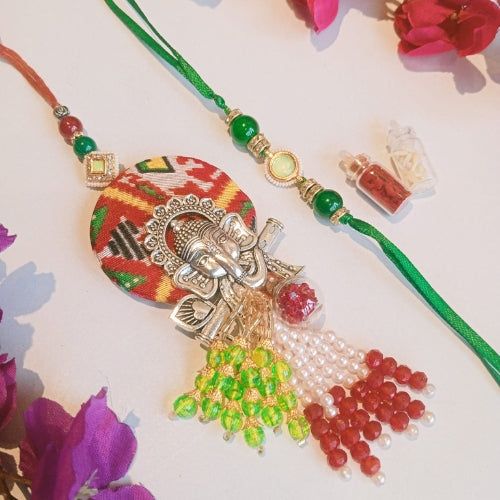 Handmade Bhaiya Bhabhi Rakhi Set – Ethnic Ganesha Motif with Multicolor Tassels & Green Thread