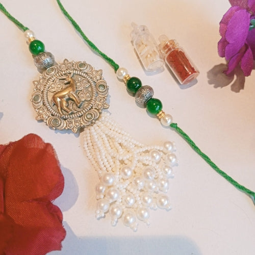 Handmade Ethnic Bhaiya Bhabhi Rakhi Set – Green Thread with Silver Deer Charm & Pearl Tassels (35g)