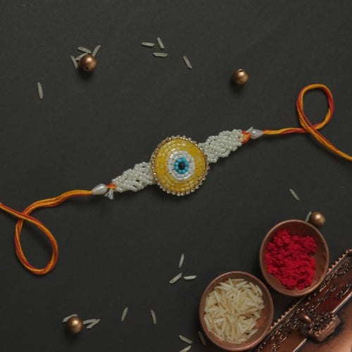 Handmade Rakhi – Yellow Beaded Rakhi with Pearls on Orange Thread