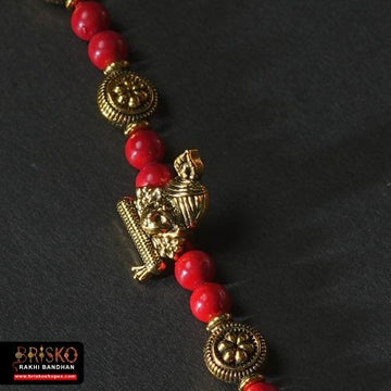 Antique Krishna Rakhi with Brass Murli Motif and Red Beaded Thread – Handmade Rakhi for Brother