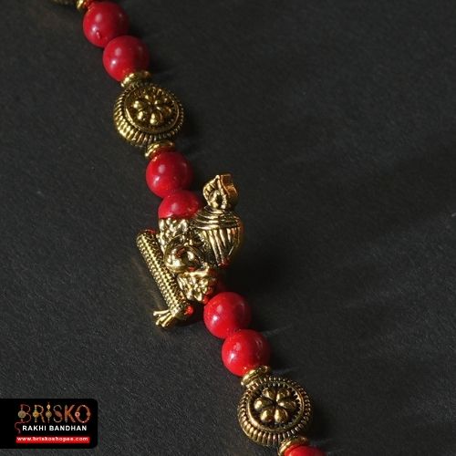 Antique Krishna Rakhi with Brass Murli Motif and Red Beaded Thread – Handmade Rakhi for Brother