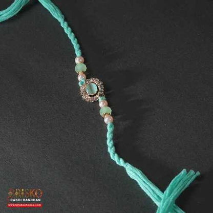 Kundan Pearl Rakhi – Elegant Multicolor Design for a Royal Bond