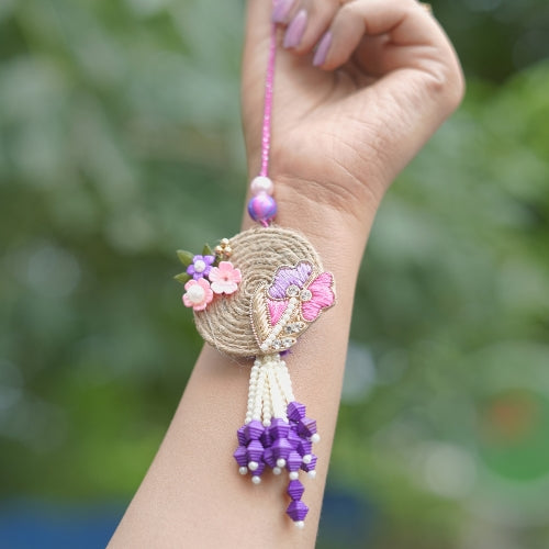 Handmade Bhaiya Bhabhi Rakhi Pair – Rustic Jute Floral Design with Pearls & Purple Tassels