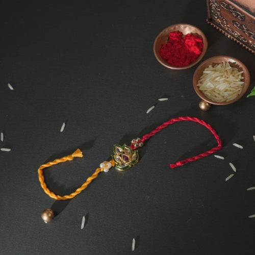 Handmade Rakhi – Red and Yellow Dual Thread Rakhi with Kundan Leaf Design