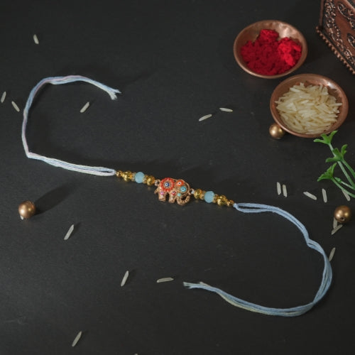 Handmade Rakhi – Blue Thread Rakhi with Enamel Elephant Charm & Golden Beads