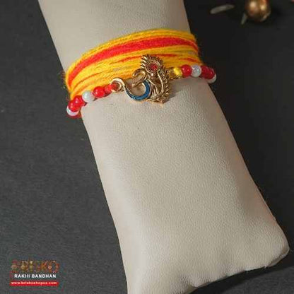 Om Morpankh Rakhi with Yellow-Red Long Cotton Thread – Spiritual Handmade Rakhi for Brother