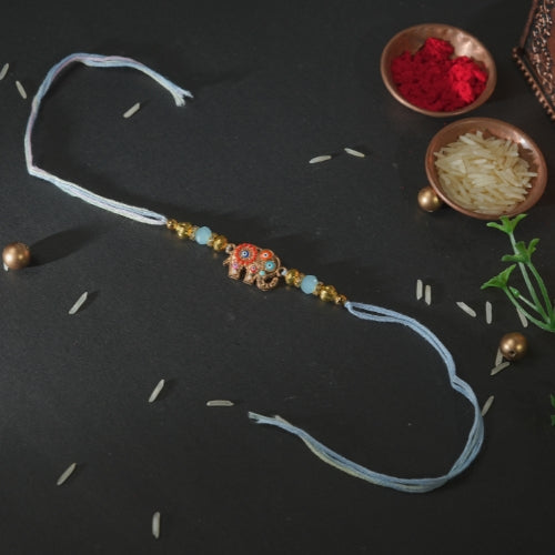 Handmade Rakhi – Blue Thread Rakhi with Enamel Elephant Charm & Golden Beads