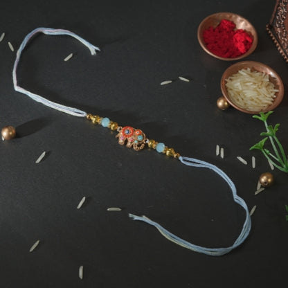 Handmade Rakhi – Blue Thread Rakhi with Enamel Elephant Charm & Golden Beads