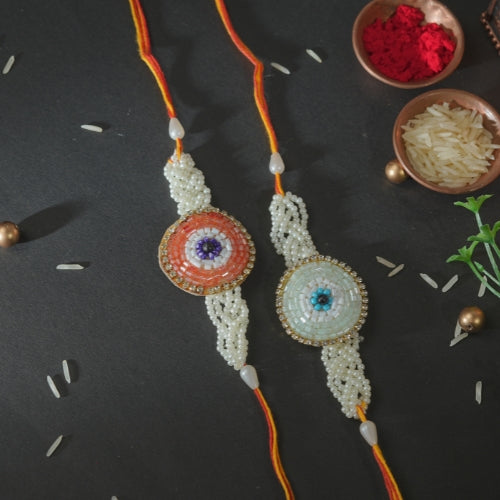 Handmade Rakhi Set – Twin Beaded Rakhis with Orange Thread & Pearl Work